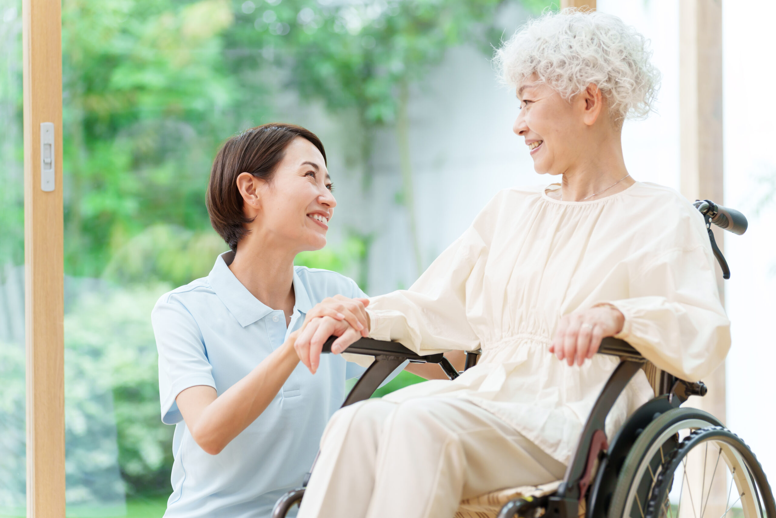 caregiver and senior woman riding wheelchair