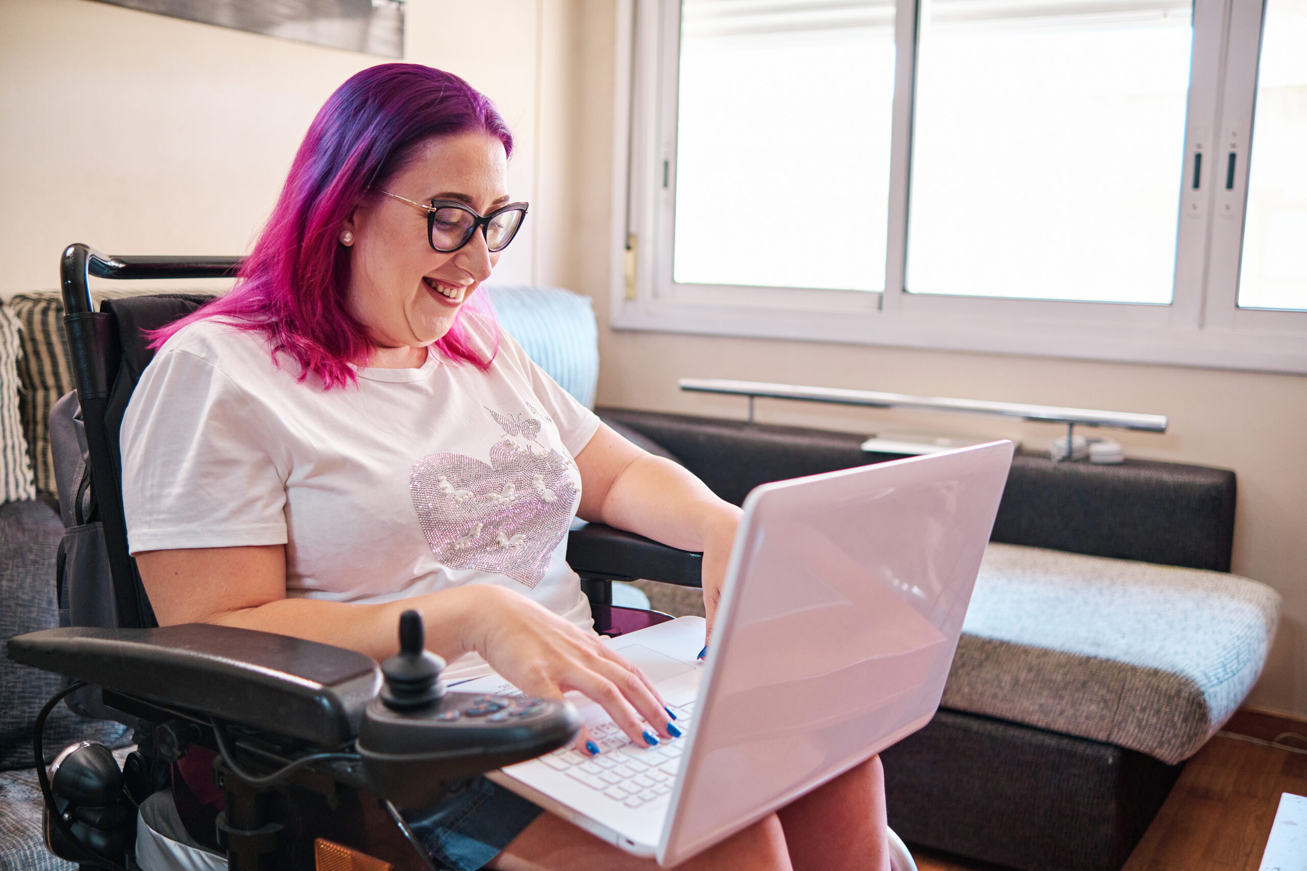 adult woman in a wheelchair using her laptop