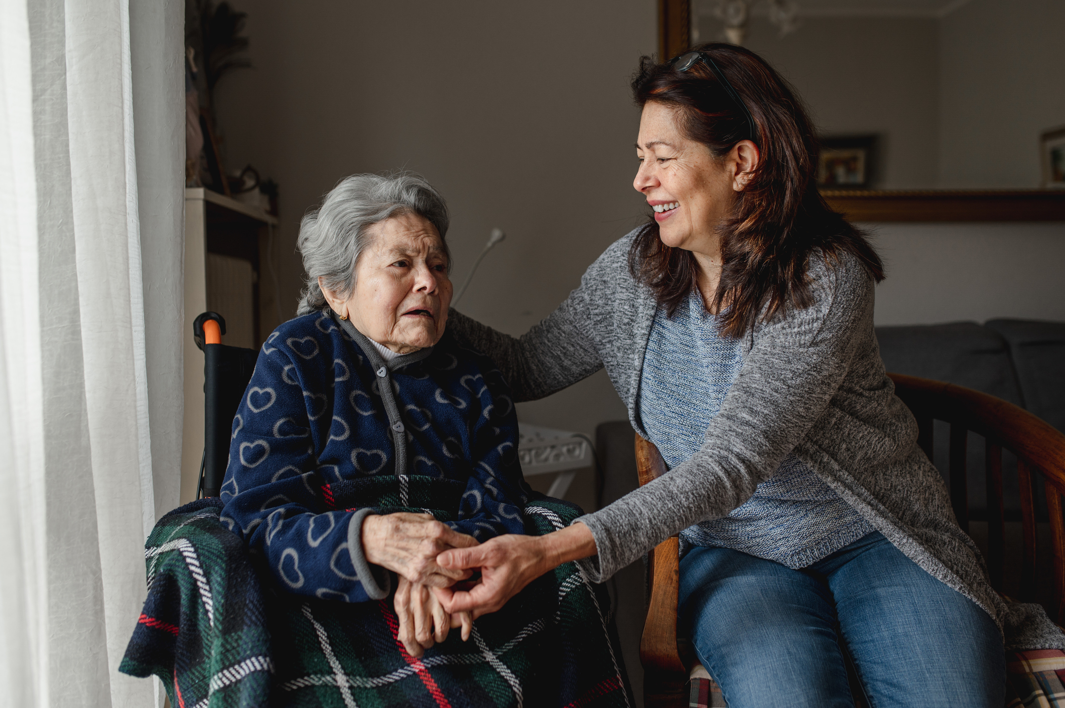 Aging woman in wheelchair next to her Caregiver